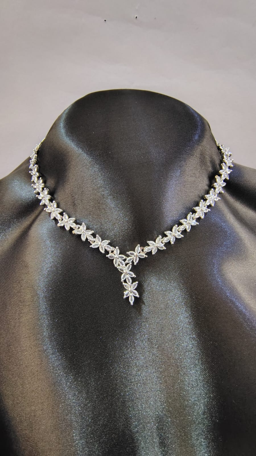 Wincham Fashion House American Diamond leaf necklace set displayed on black jewelry stand