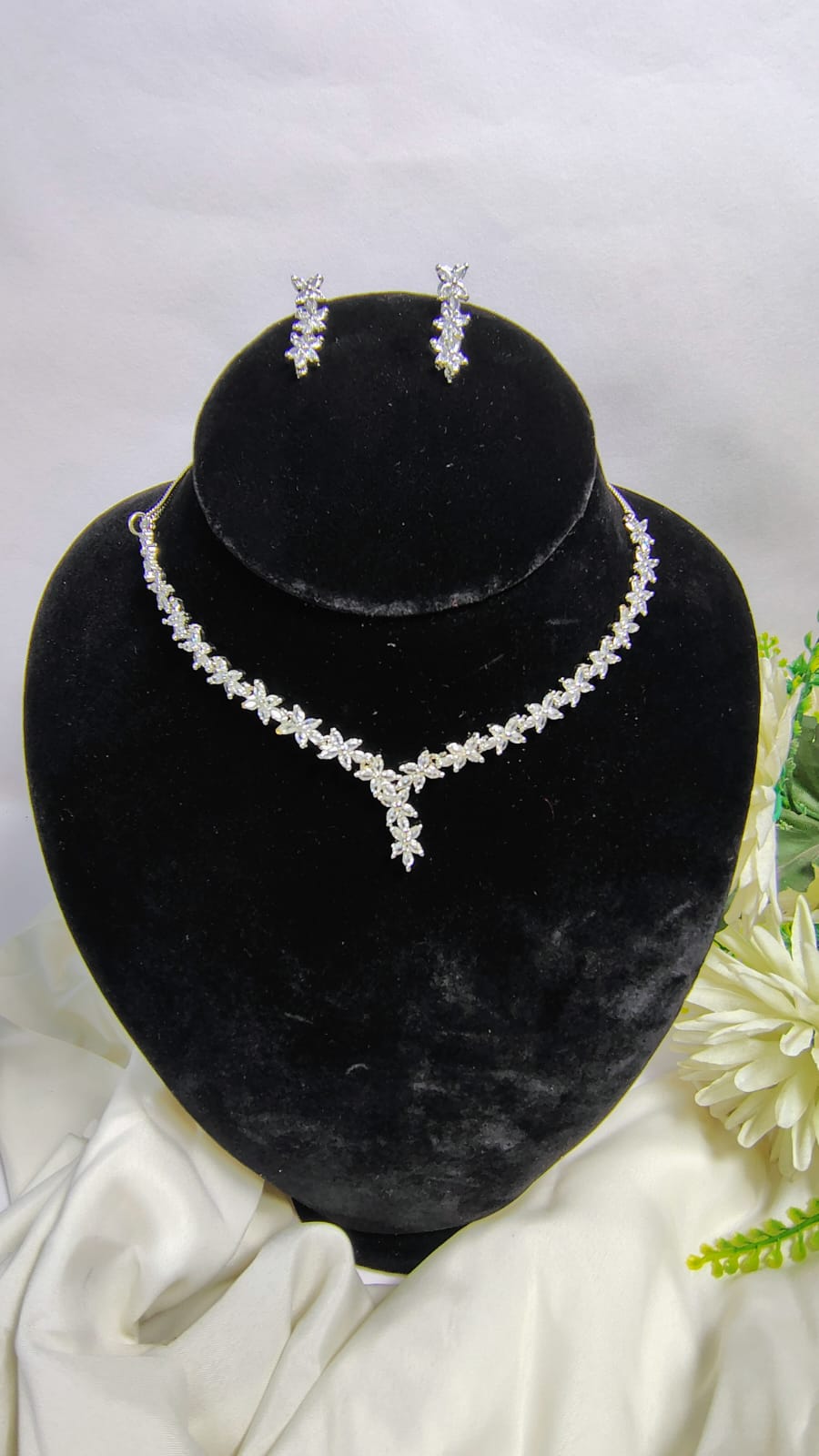 Wincham Fashion House American Diamond leaf necklace set with matching earrings displayed on black stand