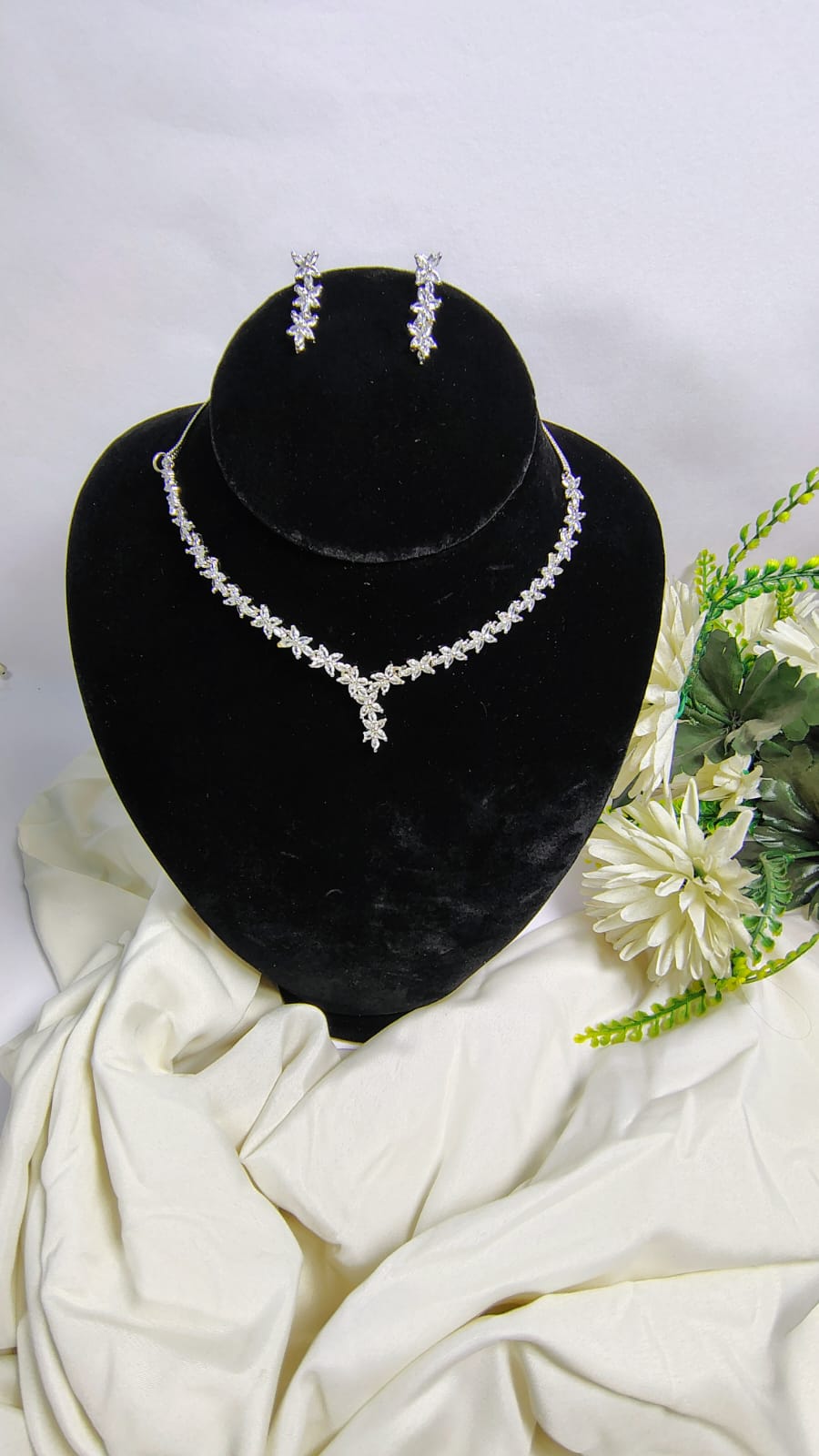 American Diamond leaf necklace set displayed on black stand with matching earrings by Wincham Fashion House