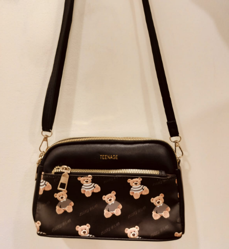 Black crossbody purse with chains featuring teddy bear print and gold zipper from My Store