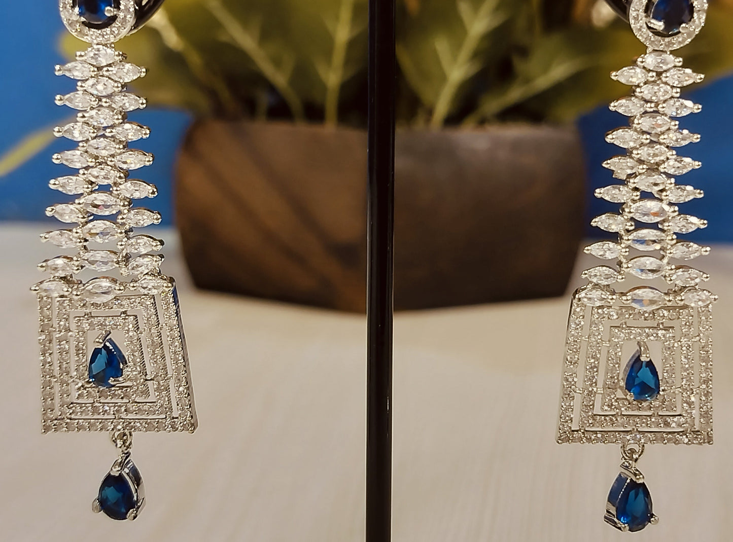 Blue stone dangle Ad earrings for Party with intricate silver design and teardrop blue stones