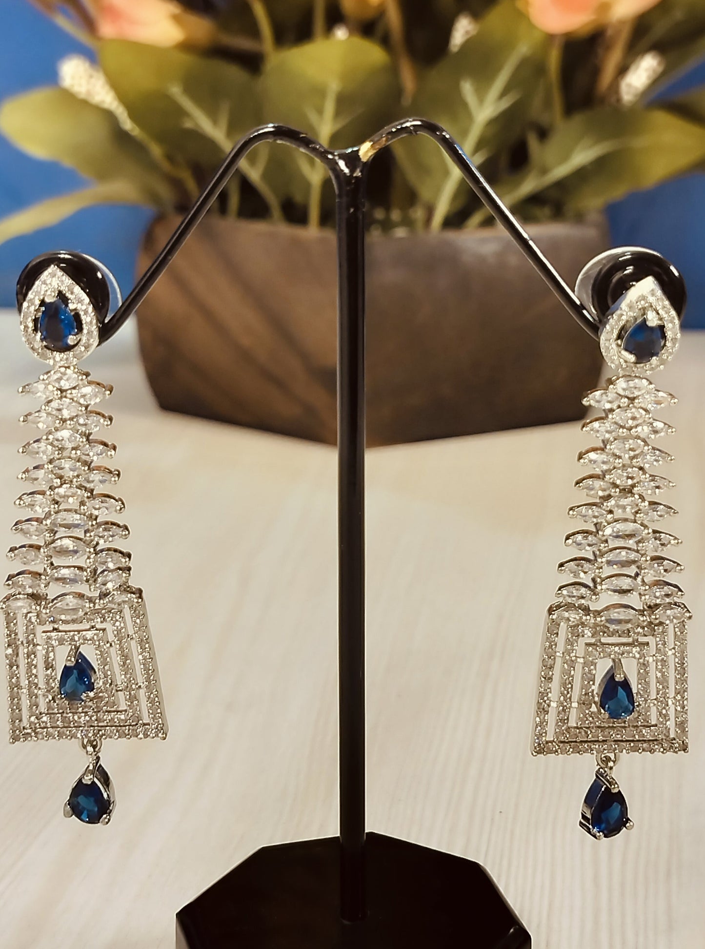 Blue stone dangle Ad earrings for Party with intricate silver design and teardrop-shaped blue stones