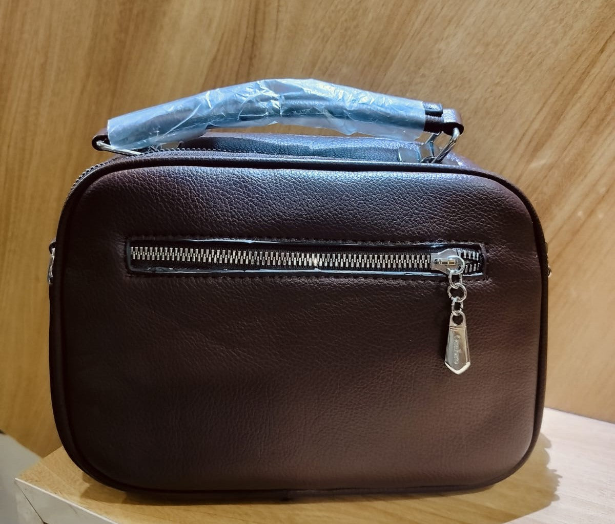 Brown leather bag with front zipper pocket and wrapped handle from My Store