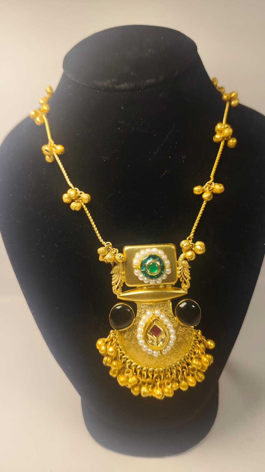 Designer party wear necklace set with intricate gold detailing and colorful gemstones