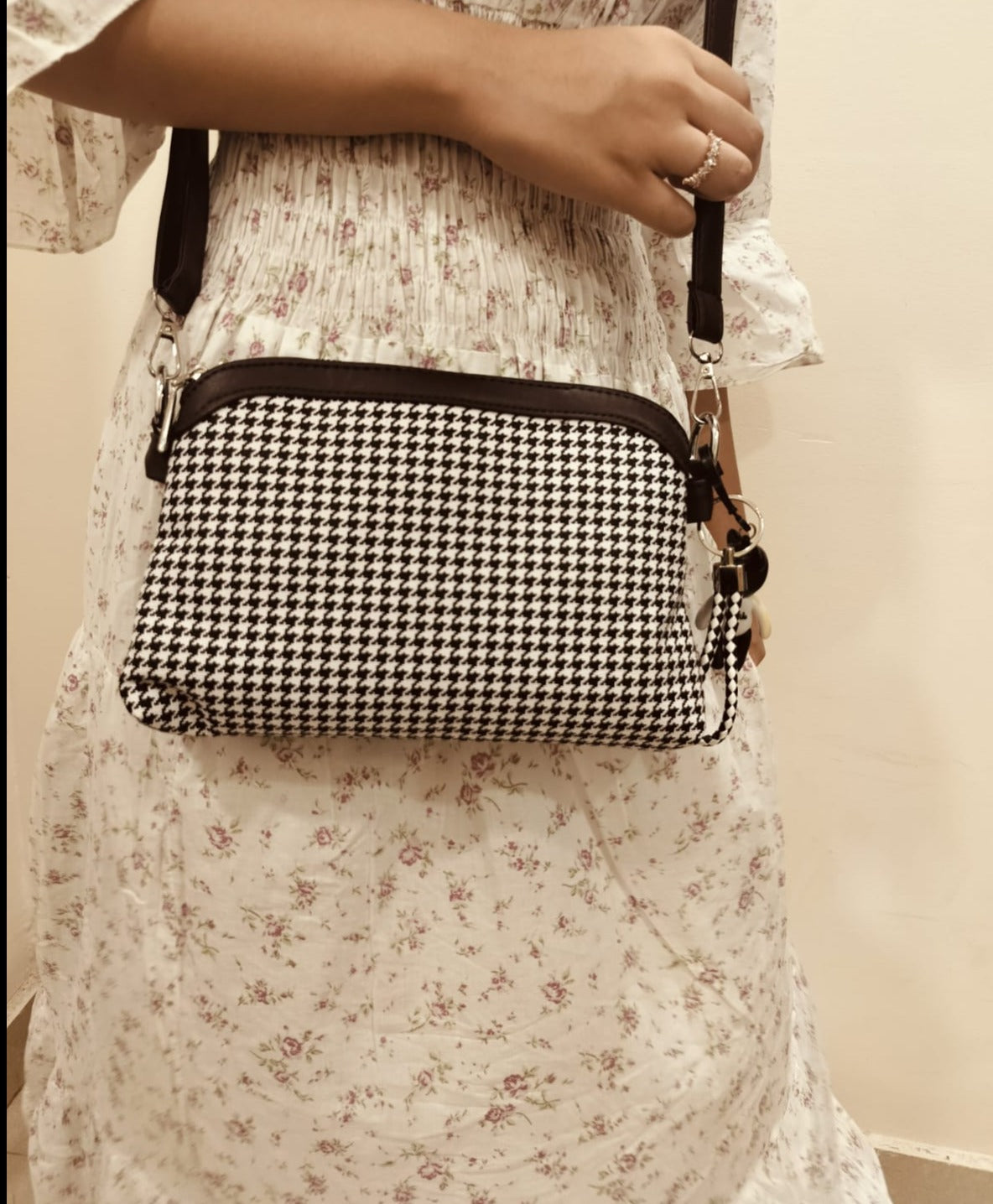 Small designer evening bag check pattern black and white with black strap worn over shoulder