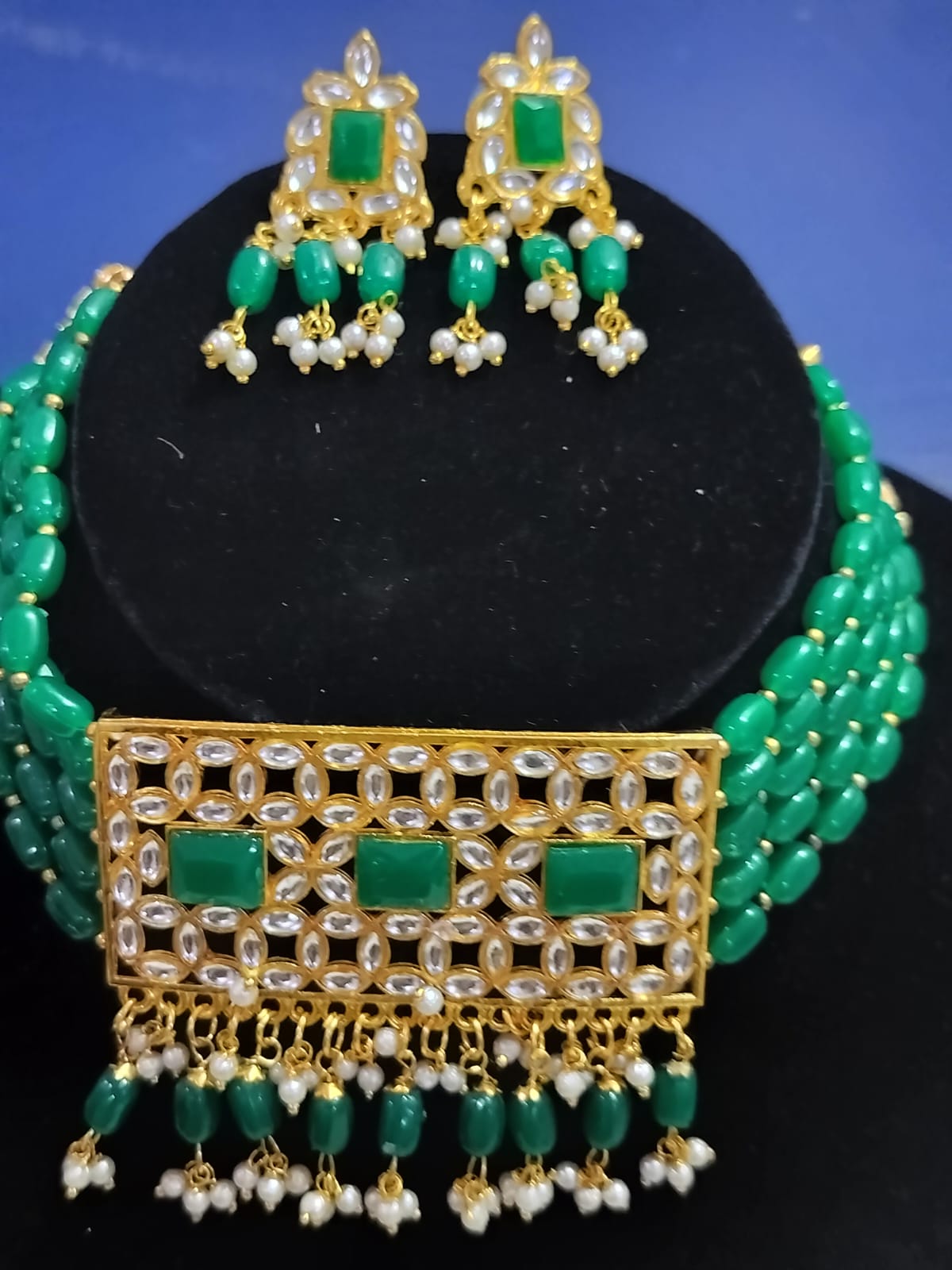 Emerald green kundan choker set with gold detailing and matching earrings from Wincham Fashion House
