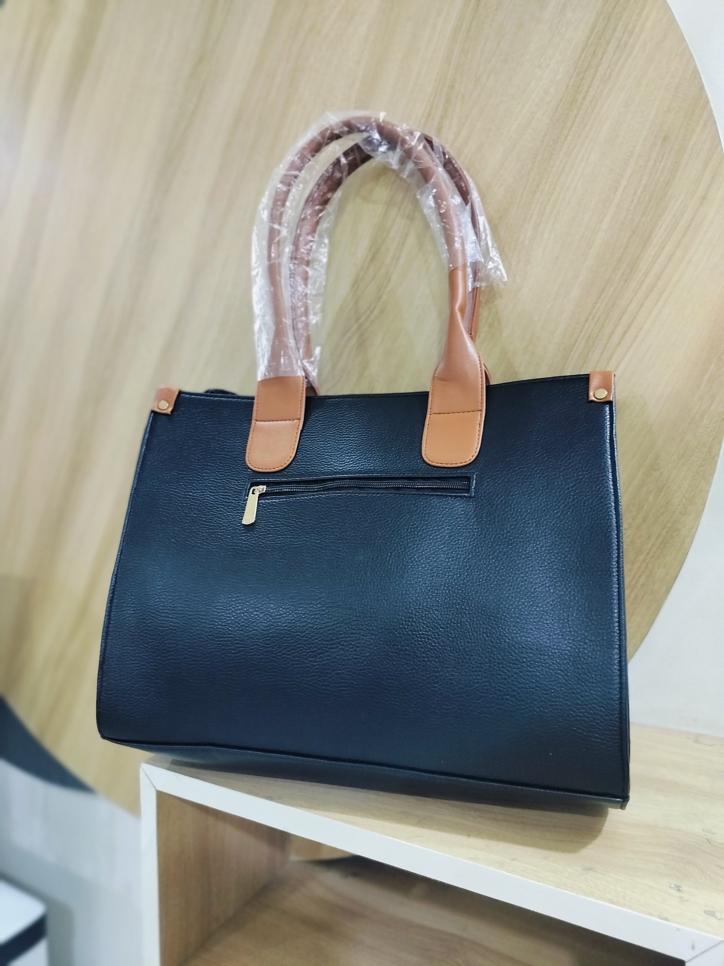 Wincham Fashion House black handmade leather laptop tote with tan handles and front zipper pocket