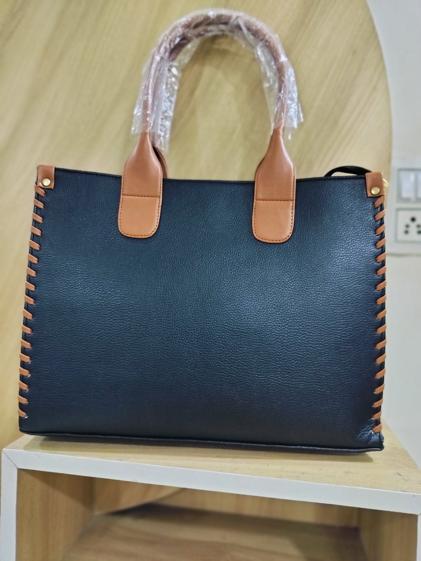 Wincham Fashion House handmade leather laptop tote in black with brown handles and stitched detailing