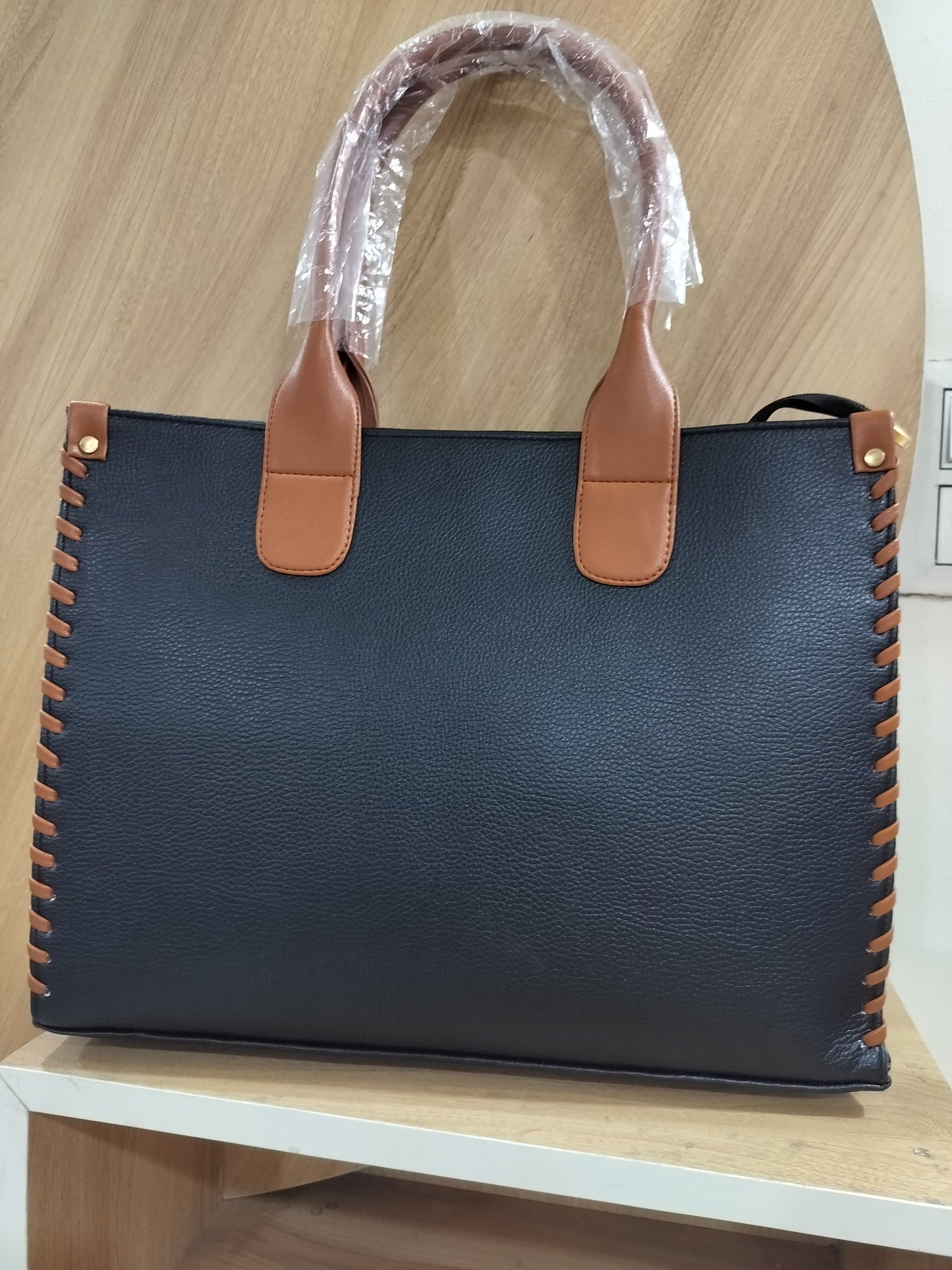 Wincham Fashion House handmade leather laptop tote in black with brown handles and side stitching