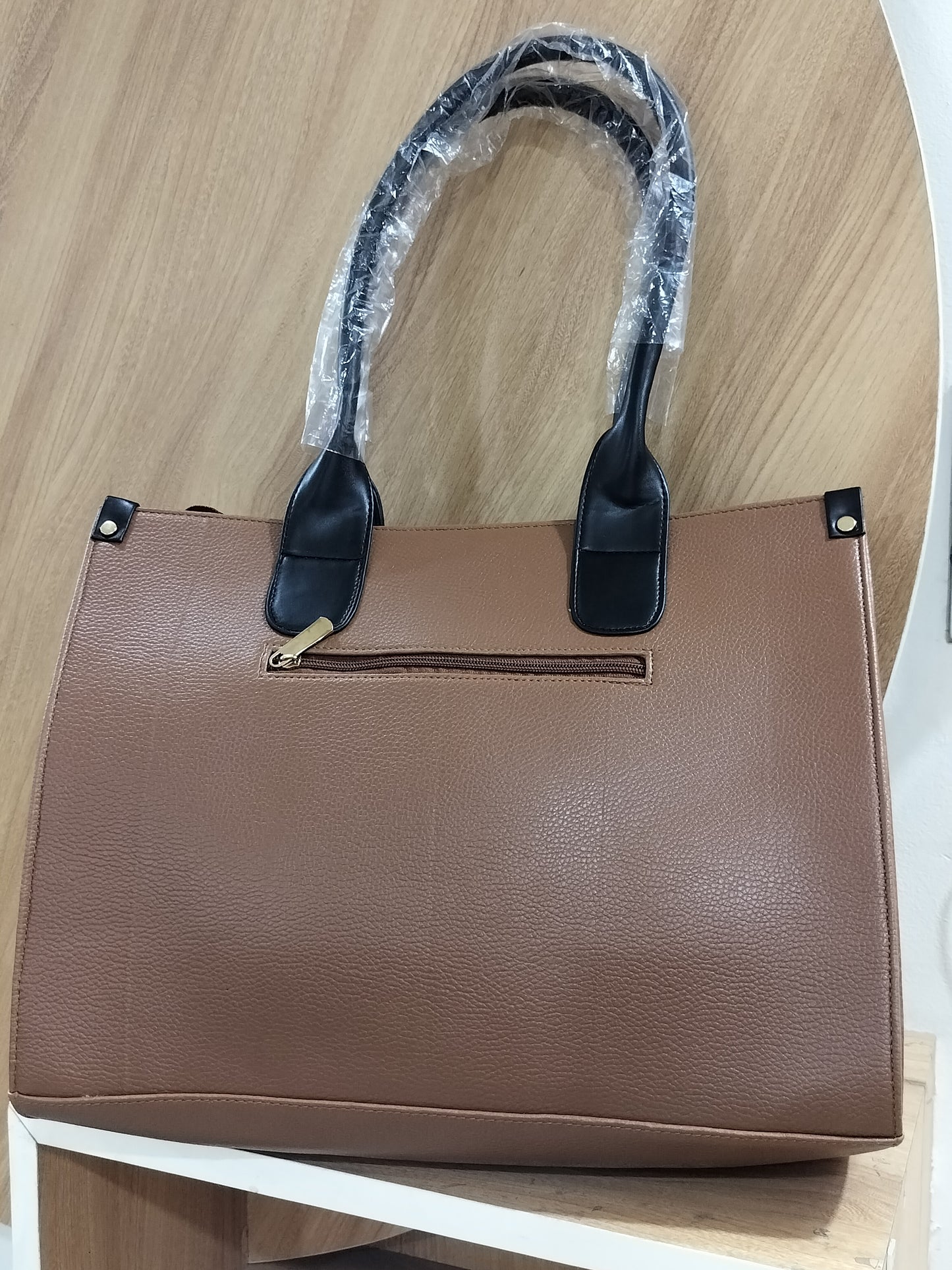 Wincham Fashion House brown handmade leather laptop tote with black handles and zipper pocket