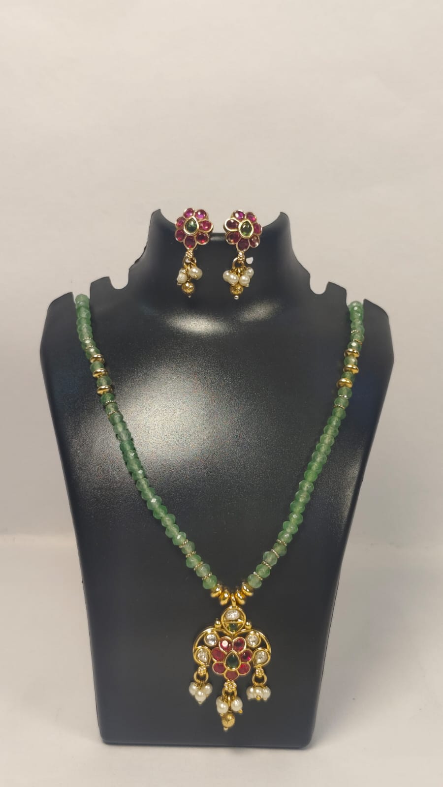 Elegant jodhpuri necklace set with earrings featuring green beads and intricate gold detailing