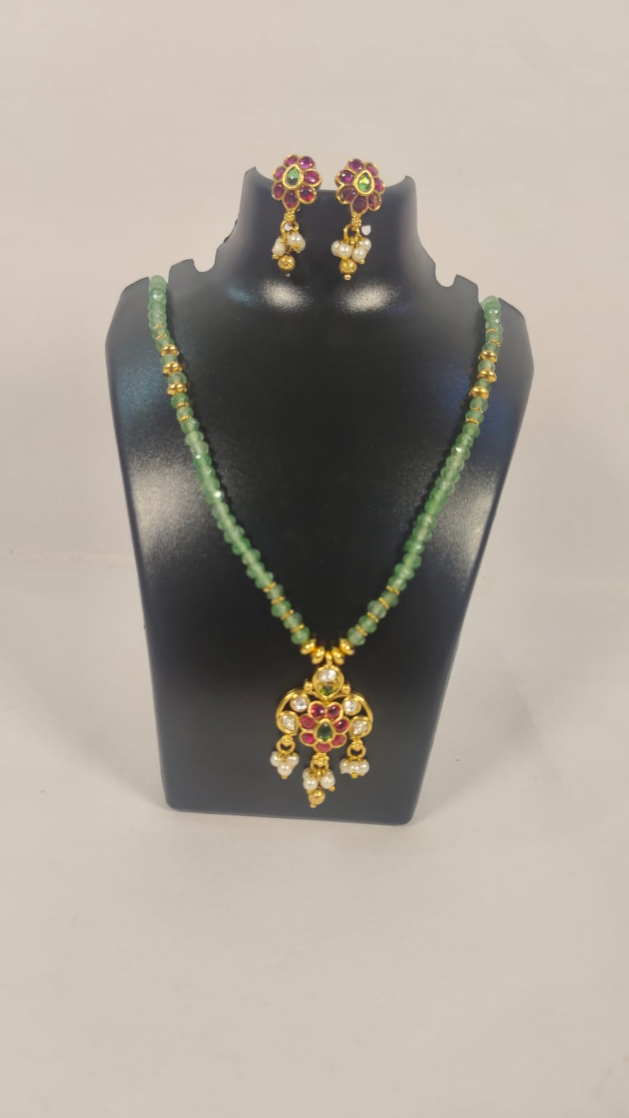 Elegant jodhpuri necklace set with earrings featuring green beads and decorative gold accents