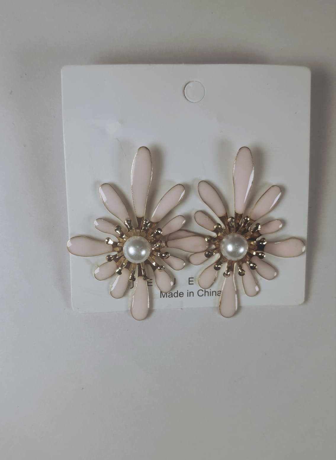 Korean flower earrings with pink petals and pearl center on white display card