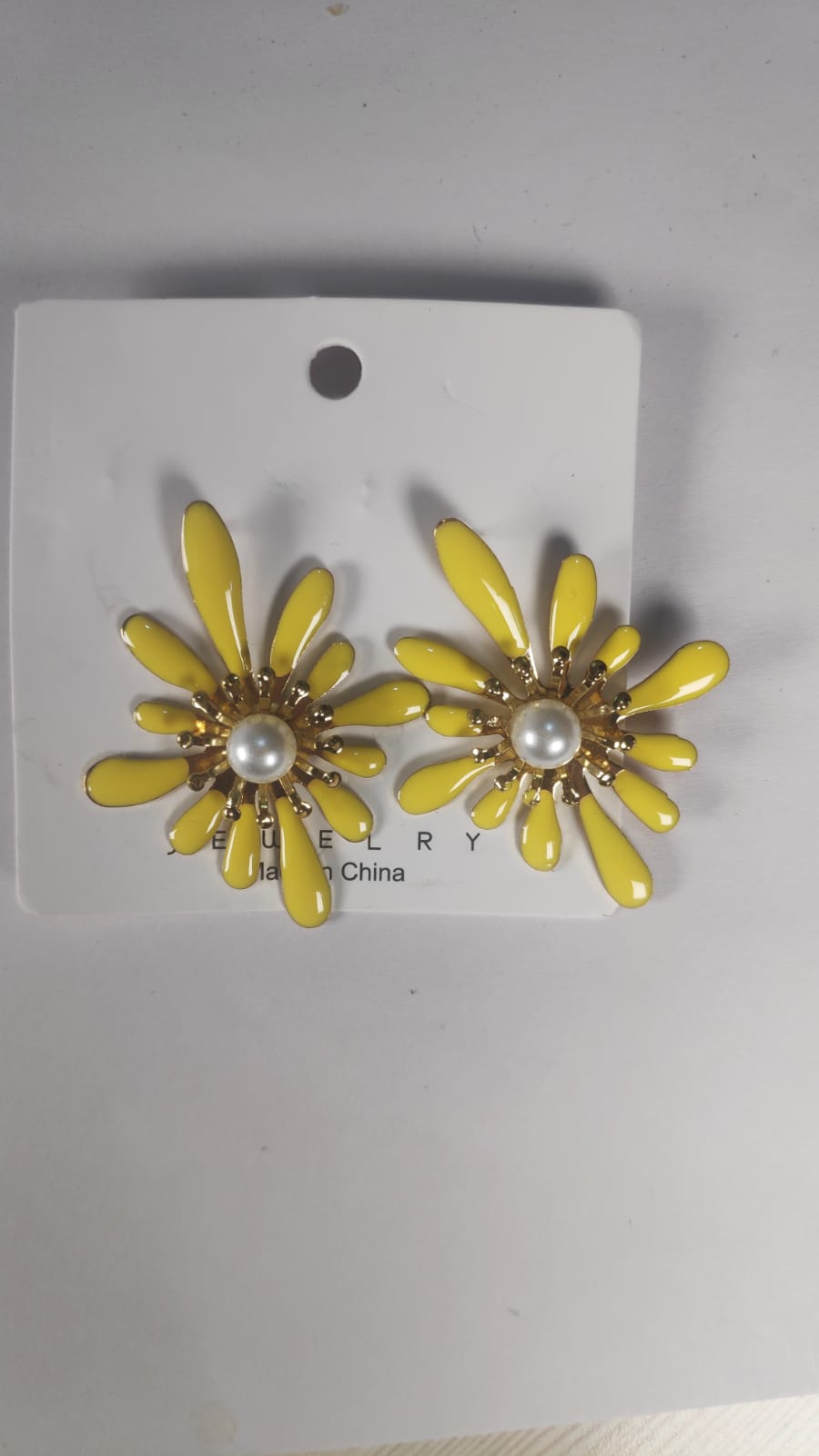 Yellow Korean flower earrings with pearl center on white display card from My Store