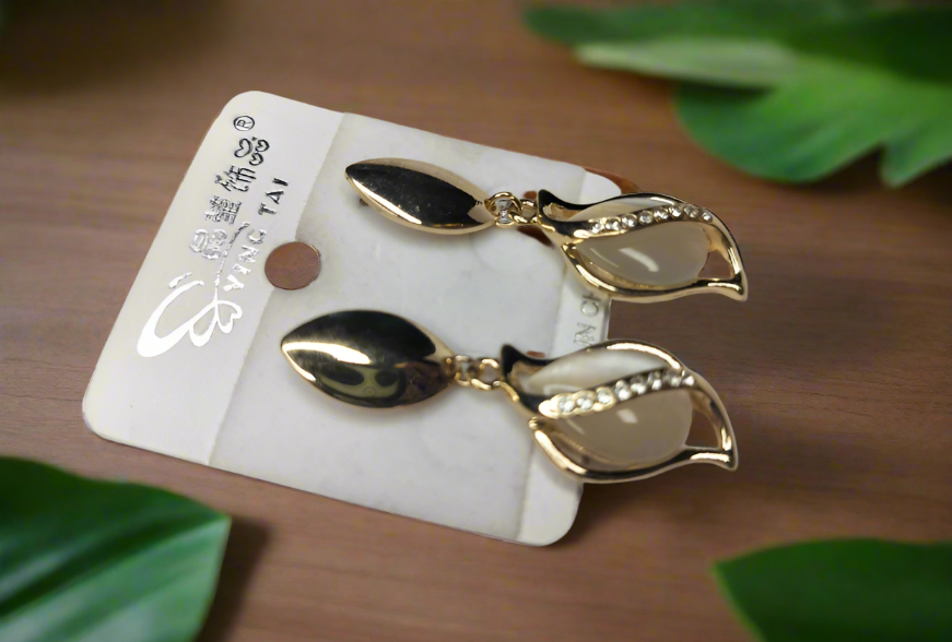 Elegant Korean gold earrings with leaf design and pearl accents on white card