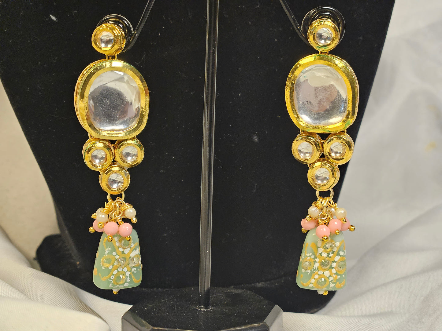 Gold-tone earrings with clear stones and floral designs in pink and green Indian jewelry set by Wincham Fashion House