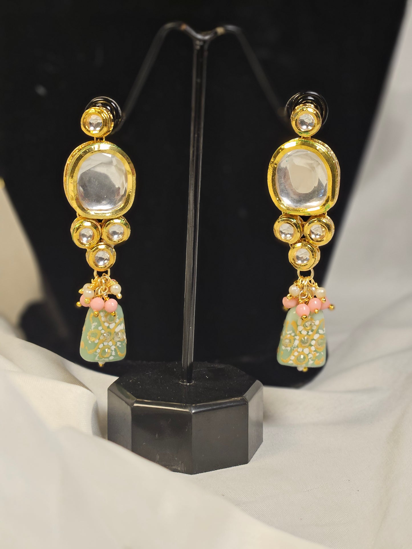 Gold tone earrings with pink and green Indian jewelry set by Wincham Fashion House featuring intricate design and gemstone accents
