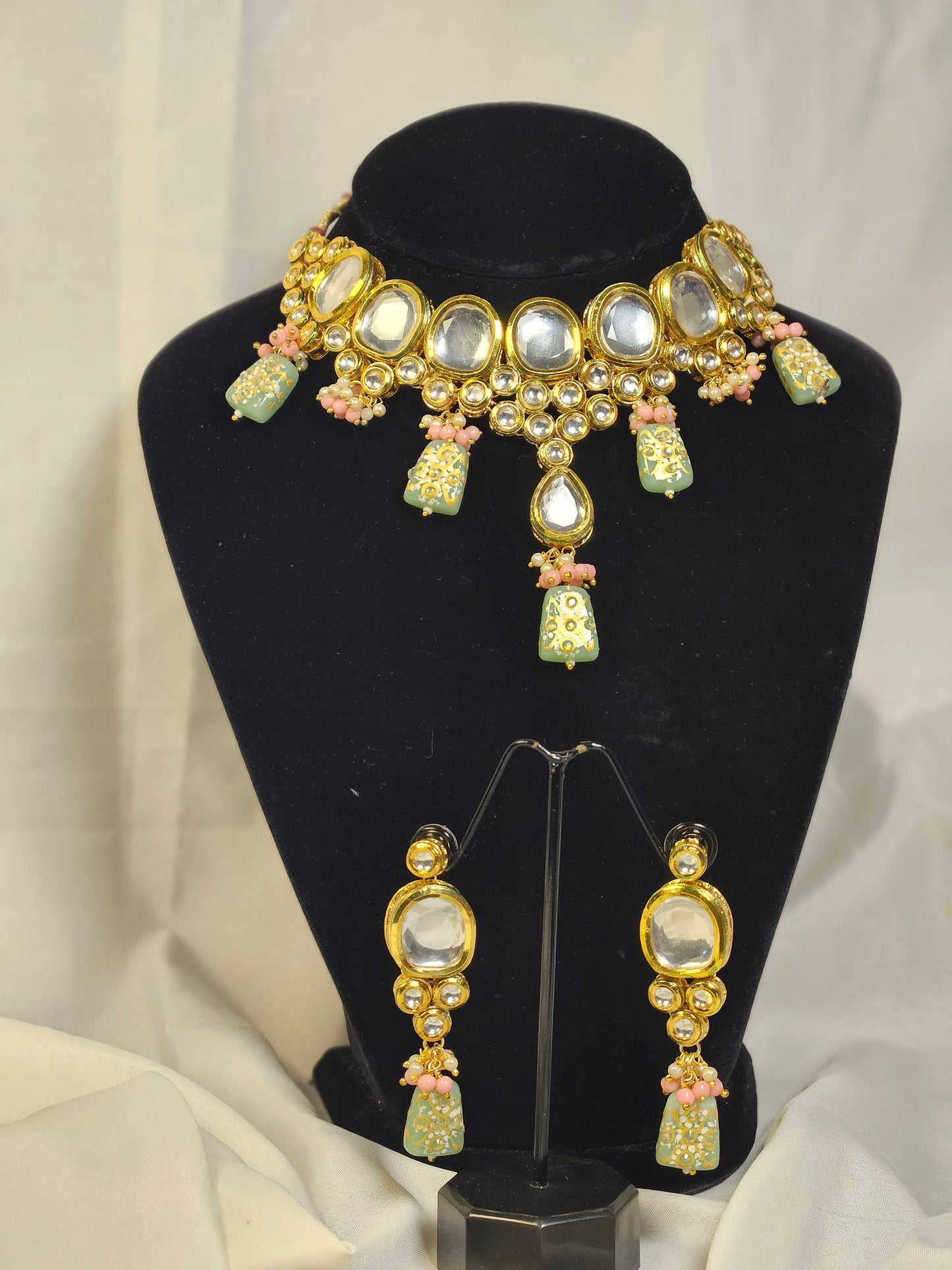 Pink and green Indian jewelry set with gold accents and mirror work necklace and earrings