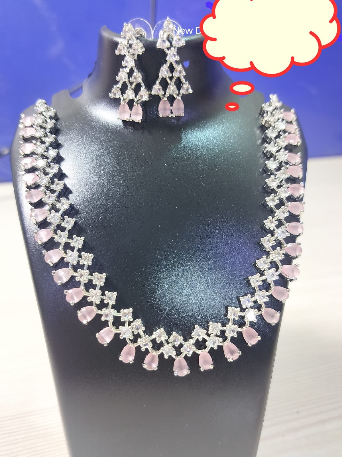 Wincham Fashion House pink stone necklace AD set with matching earrings displayed on a black stand
