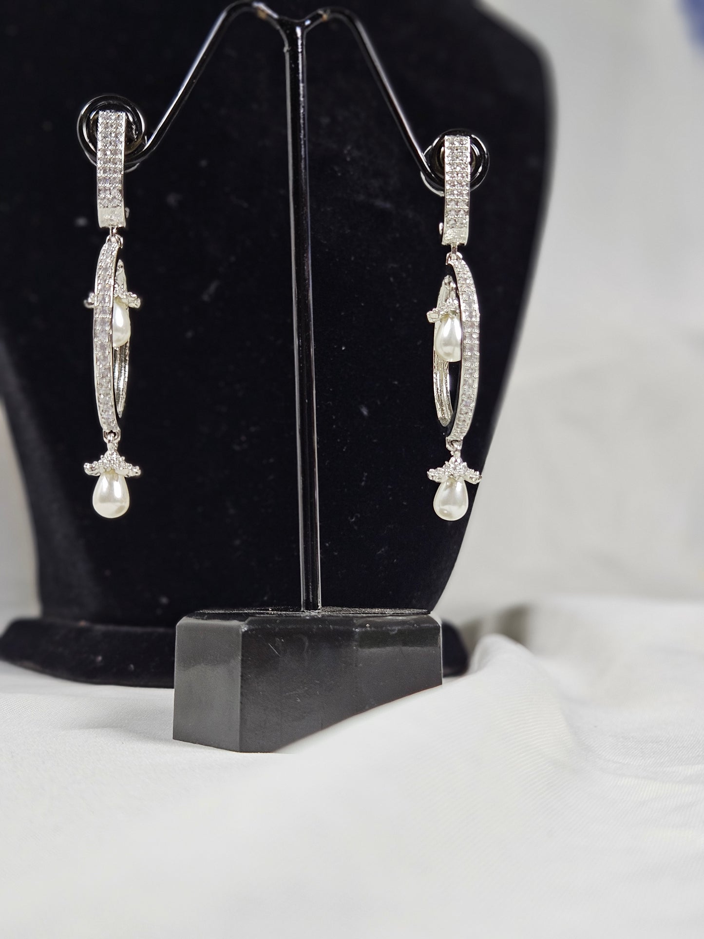 Wincham Fashion House round drop AD earrings with pearls displayed on black stand