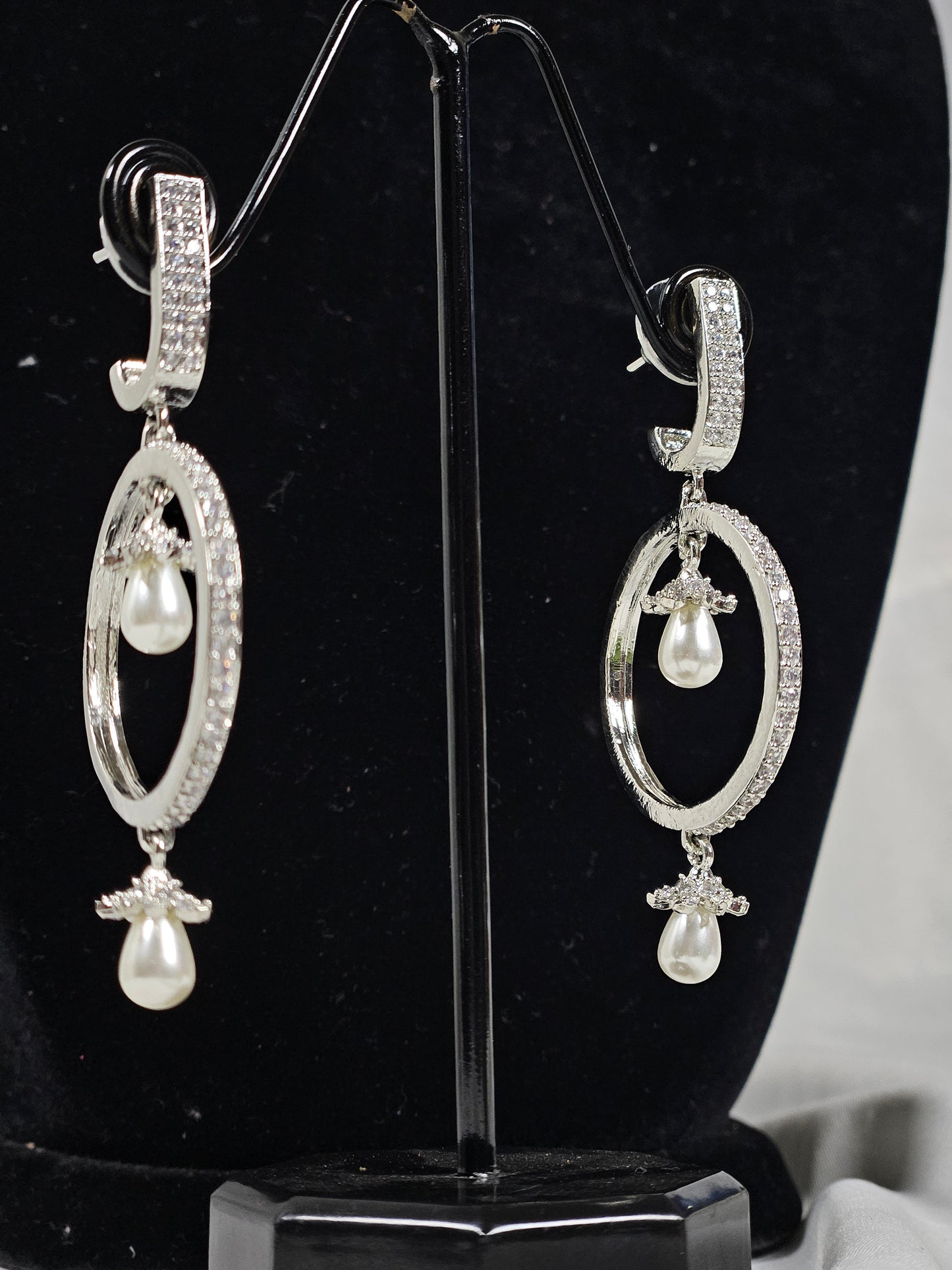 Wincham Fashion House round drop AD earrings with pearls featuring silver oval design and sparkling stones