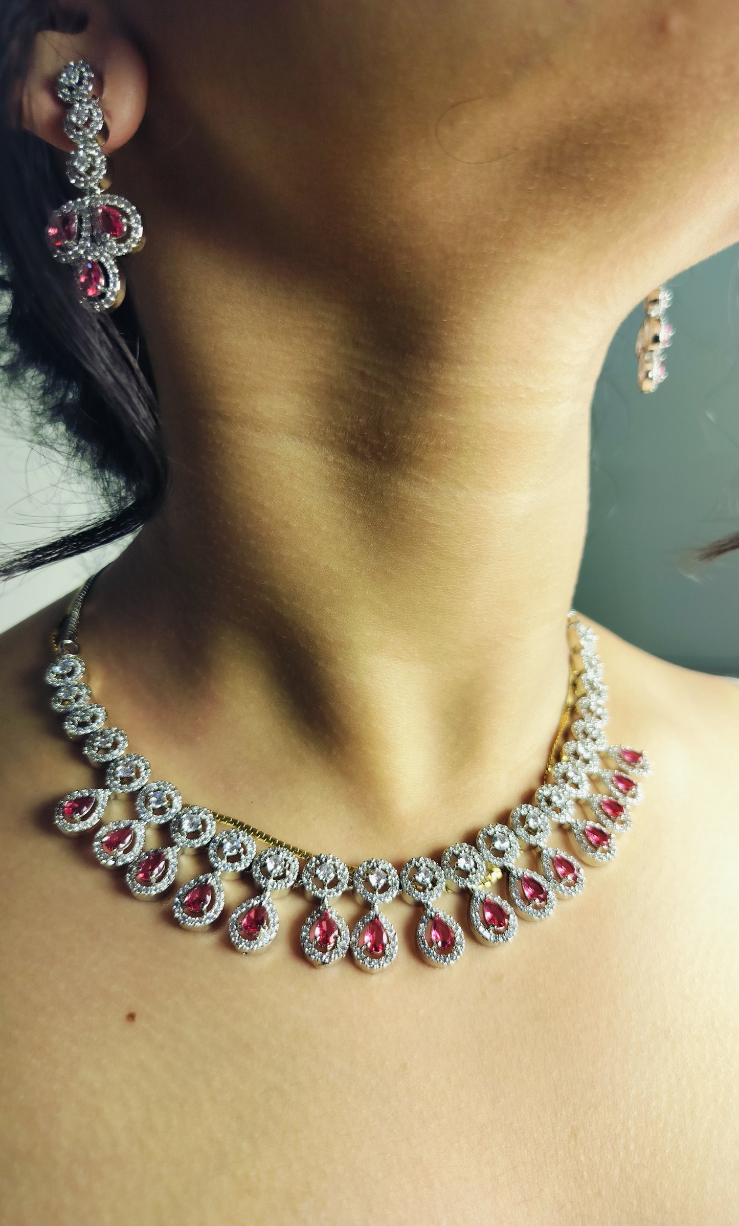 Elegant ruby leaf crystal necklace set with matching earrings featuring red and clear stones