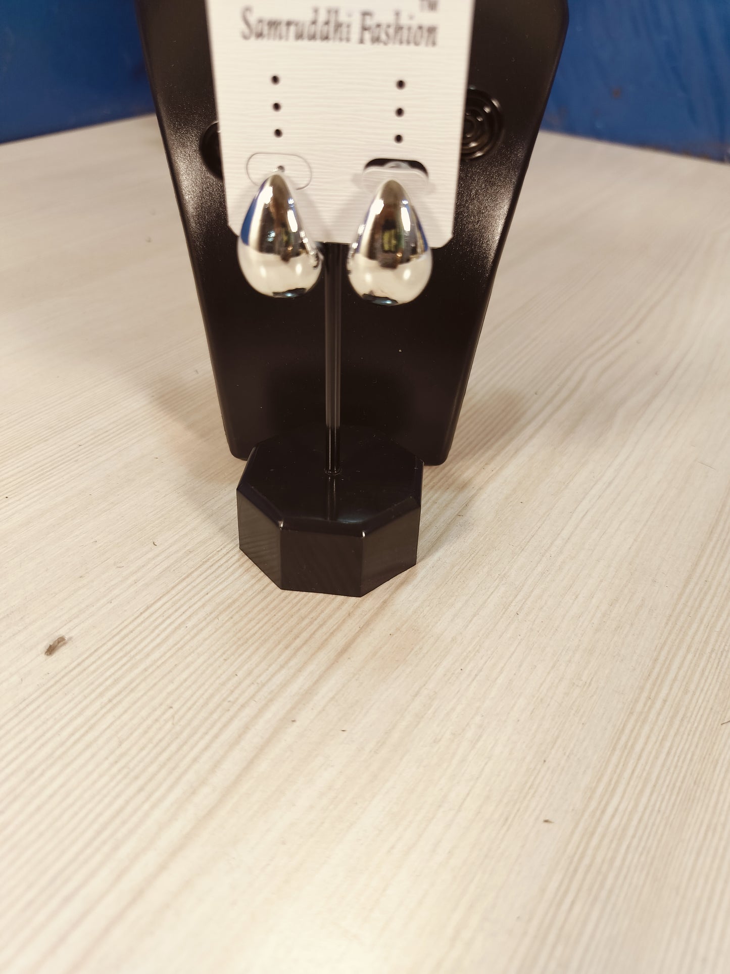 Wincham Fashion House Korean silver hoop earrings displayed on black stand with white card