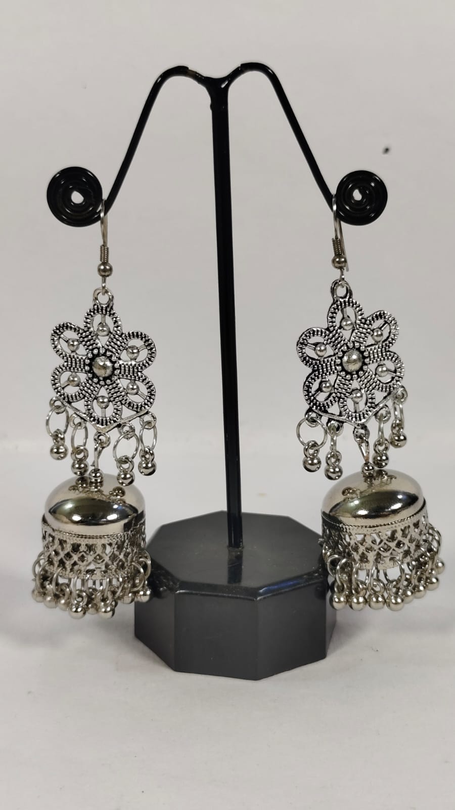 Elegant silver oxidised earrings featuring floral designs and jhumka details for a stylish look