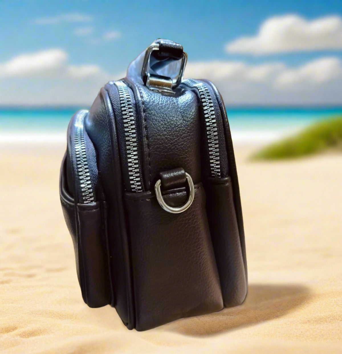 Wincham Fashion House stylish navy blue shoulder bag with multiple zippered compartments on the beach