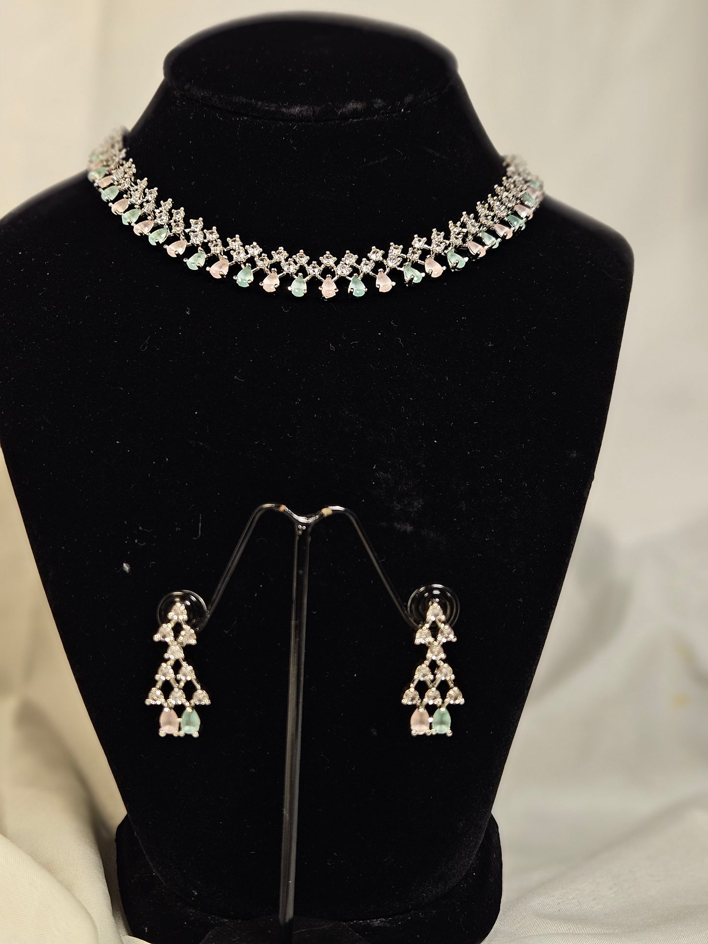 Wincham Fashion House American diamond necklace set with matching earrings on black display