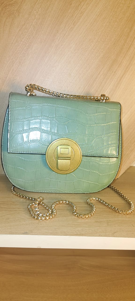 My Store white party sling purse with textured finish and gold chain strap on wooden surface