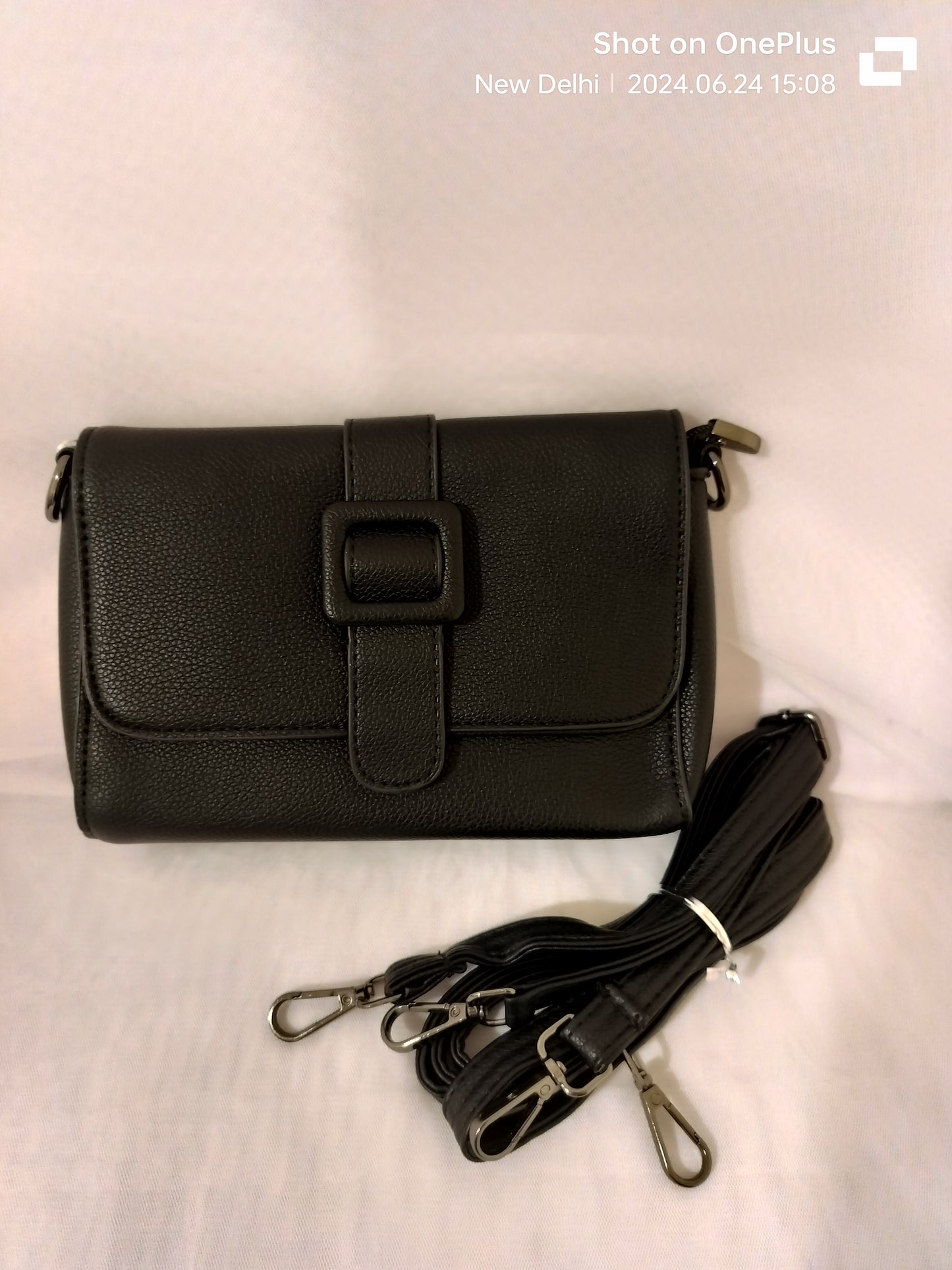 Black women's leather crossbody bag with adjustable straps and buckle detail from My Store