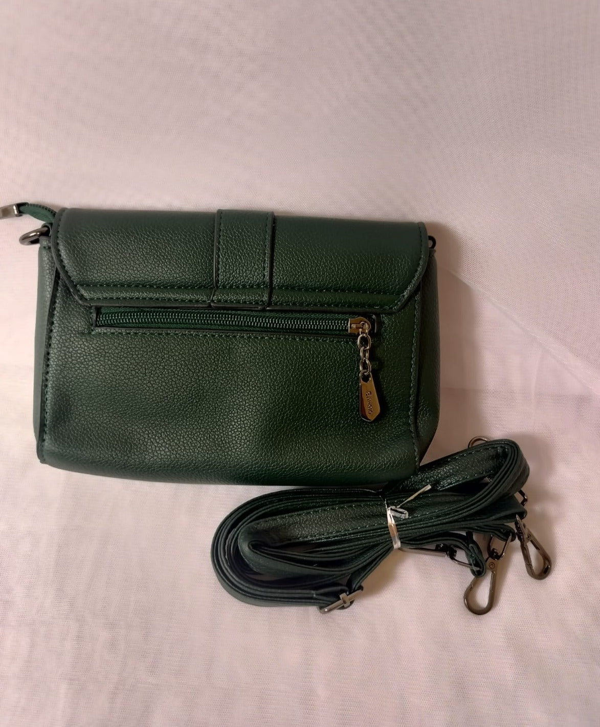 Dark green women's leather crossbody bag with zippered pocket and detachable strap