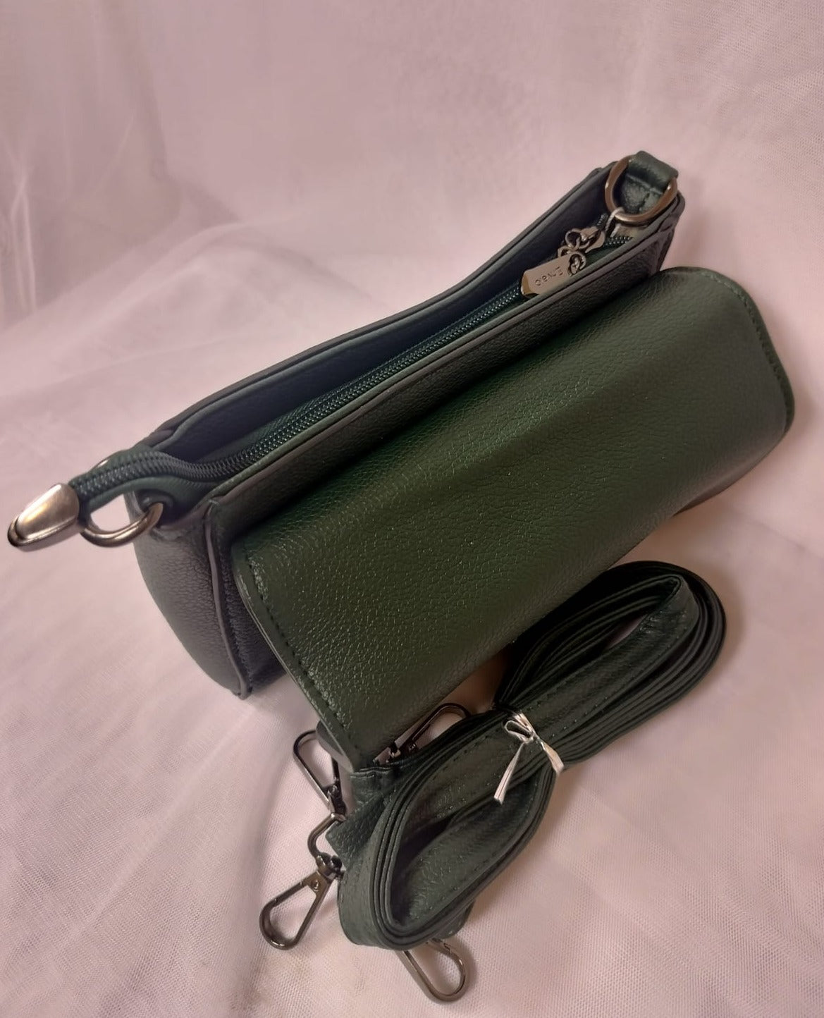 Dark green women's leather crossbody bag with zipper compartments and adjustable strap