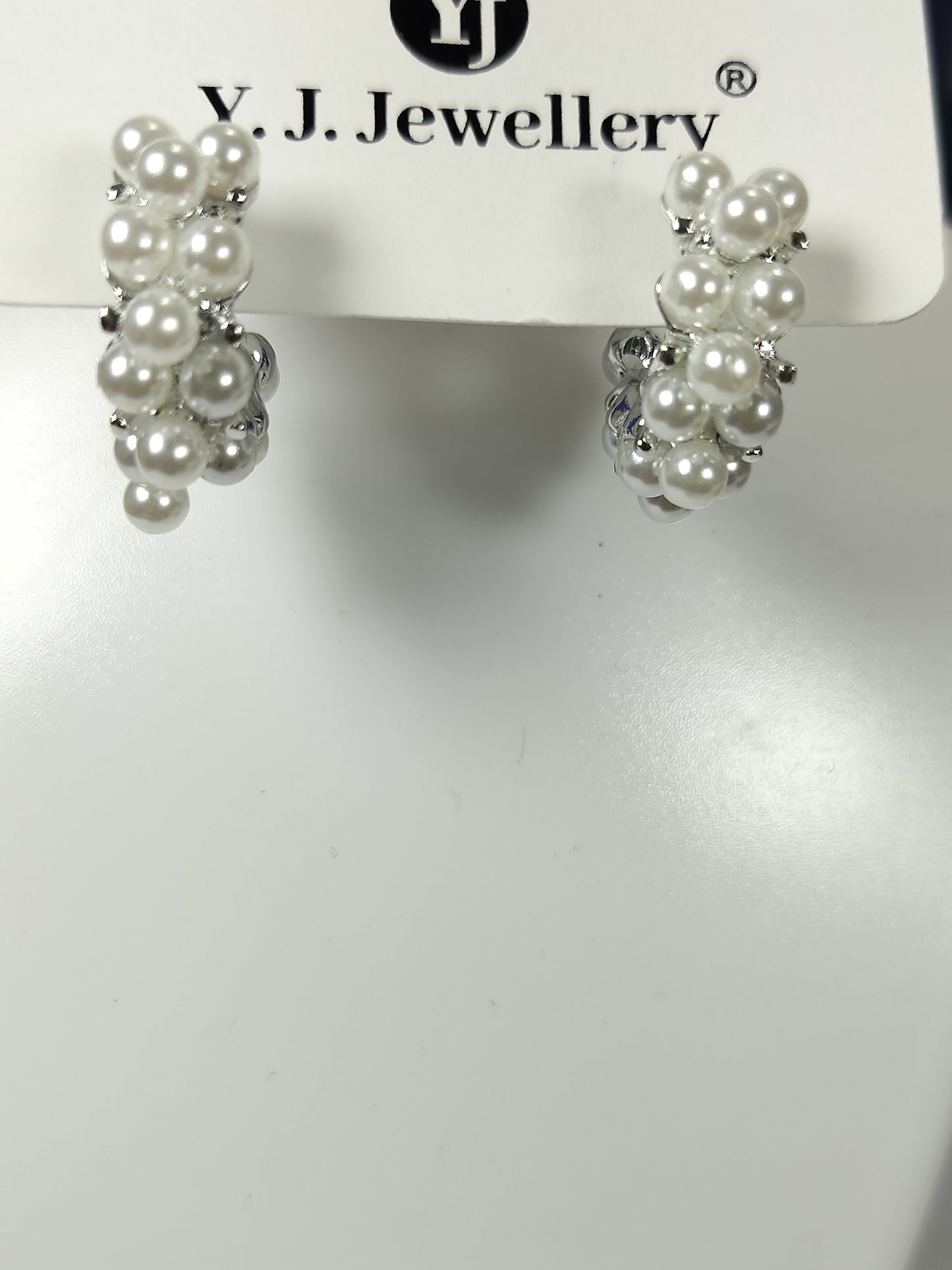 Pearl hoop earrings with clustered white pearls on silver hoops