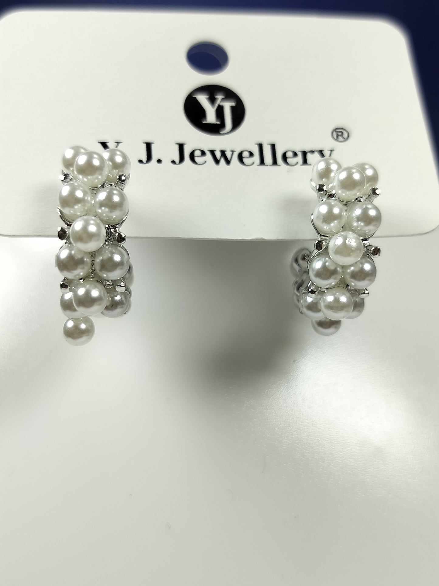 Pearl hoop earrings with clustered white pearls on silver