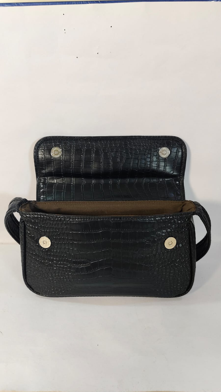 Black leather hand purse from with an elegant crocodile texture and spacious interior