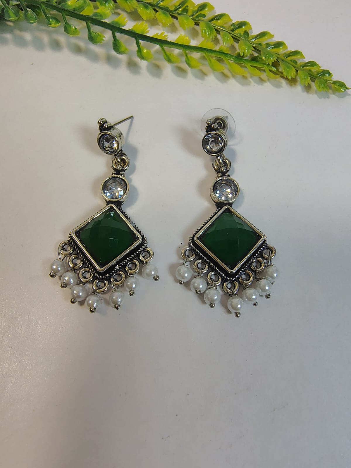 Elegant dangle earrings from Wincham Fashion House featuring green stone and pearl accents