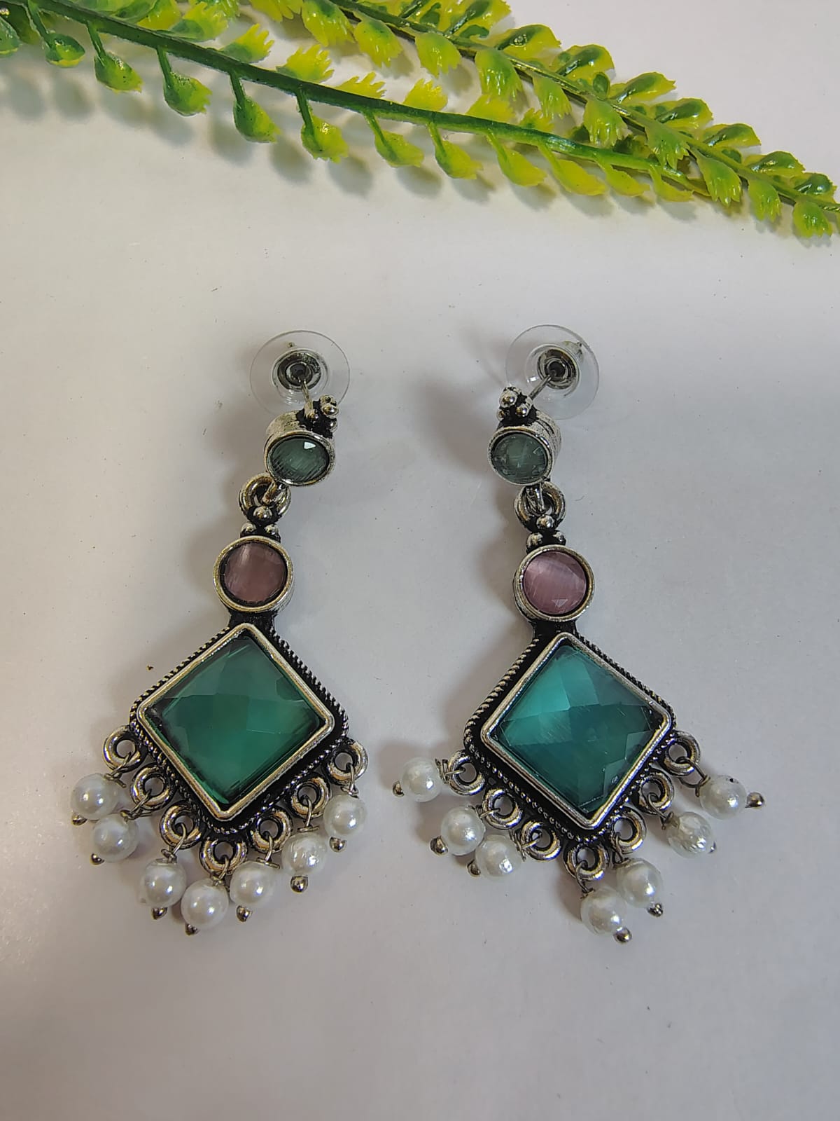 Elegant dangle earrings with turquoise and pink stones, accented by pearl drops from Wincham Fashion House