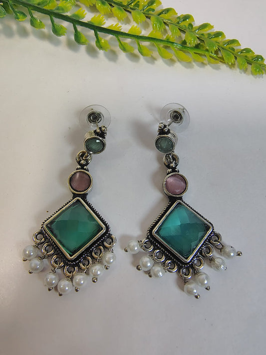 Elegant dangle earrings with turquoise and pink stones, accented by pearl drops from Wincham Fashion House