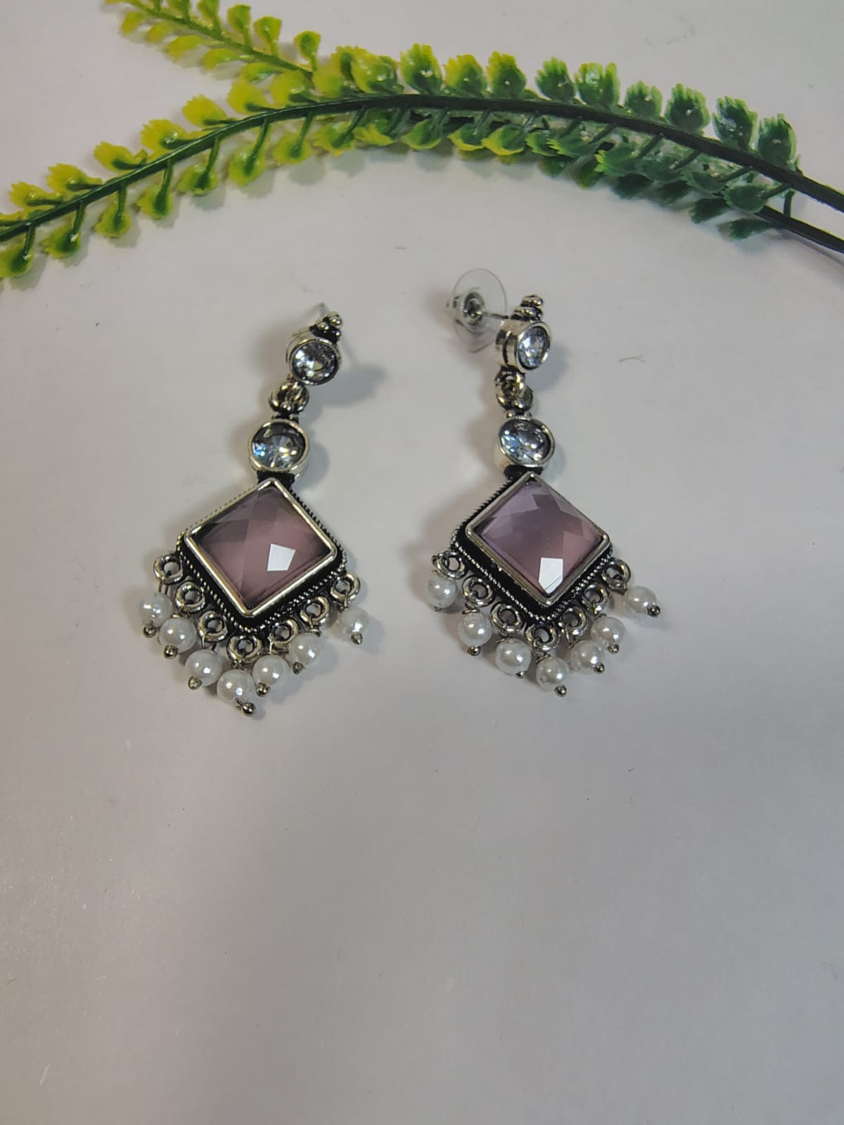 Elegant Dangle Earrings with Pearls featuring a purple faceted stone and silver accents