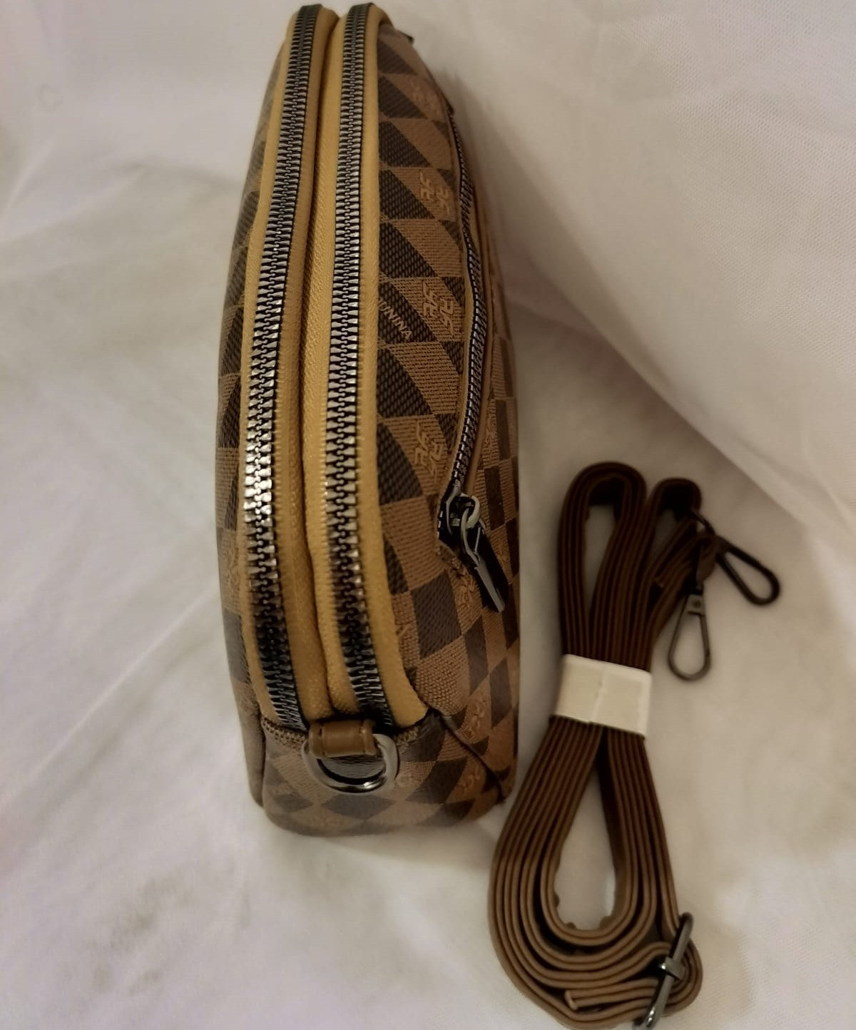 Rust brown handbag for women with checkered pattern and double zipper pockets alongside detachable strap