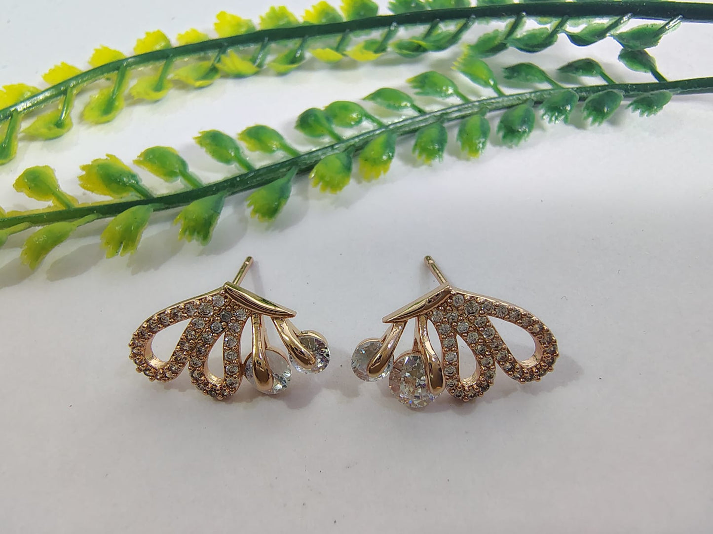 Elegant gold-tone ear stud earrings adorned with sparkling crystals for a chic look