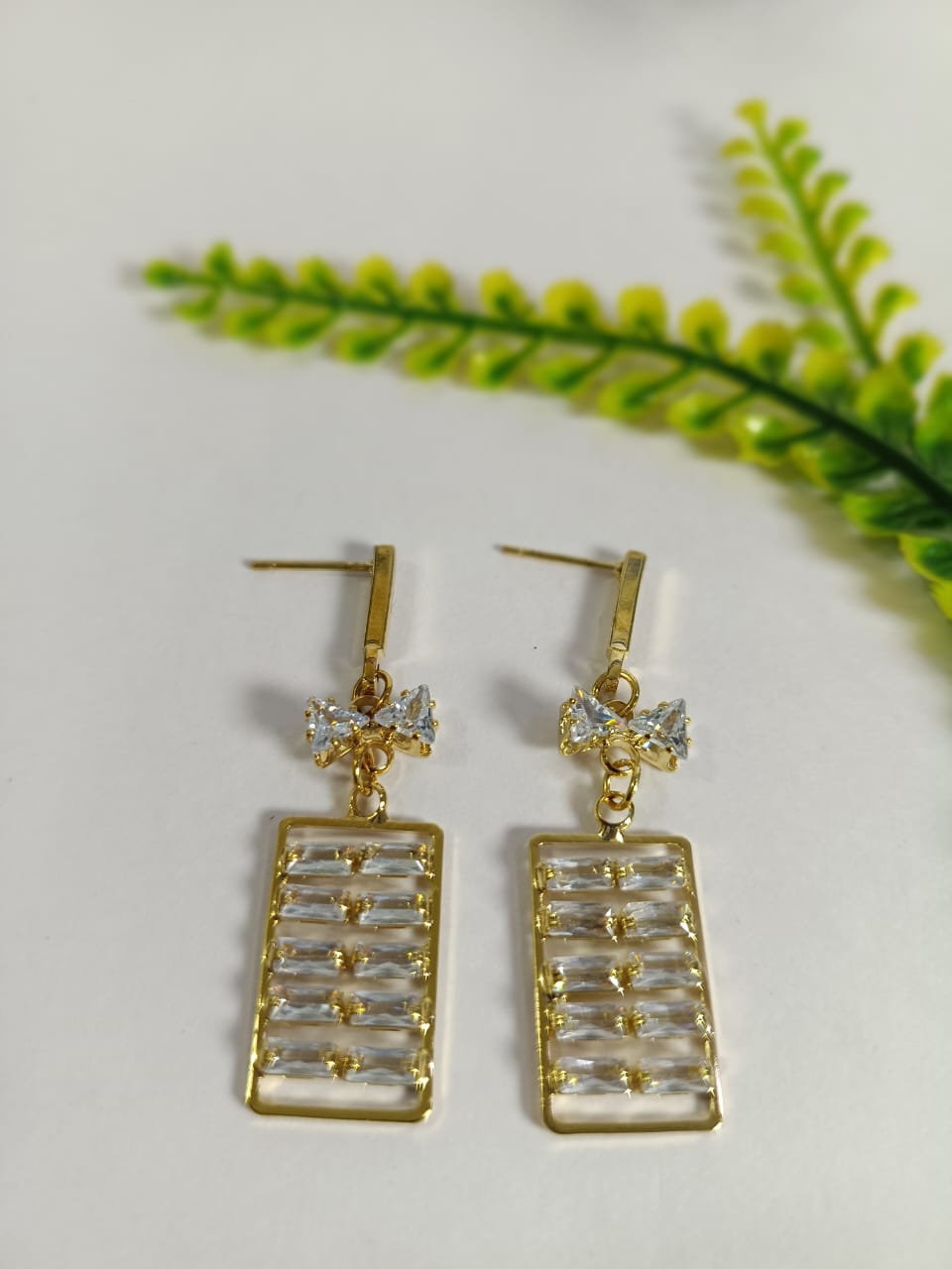 Elegant gold Ad drop earrings with crystal embellishments for fashionable looks