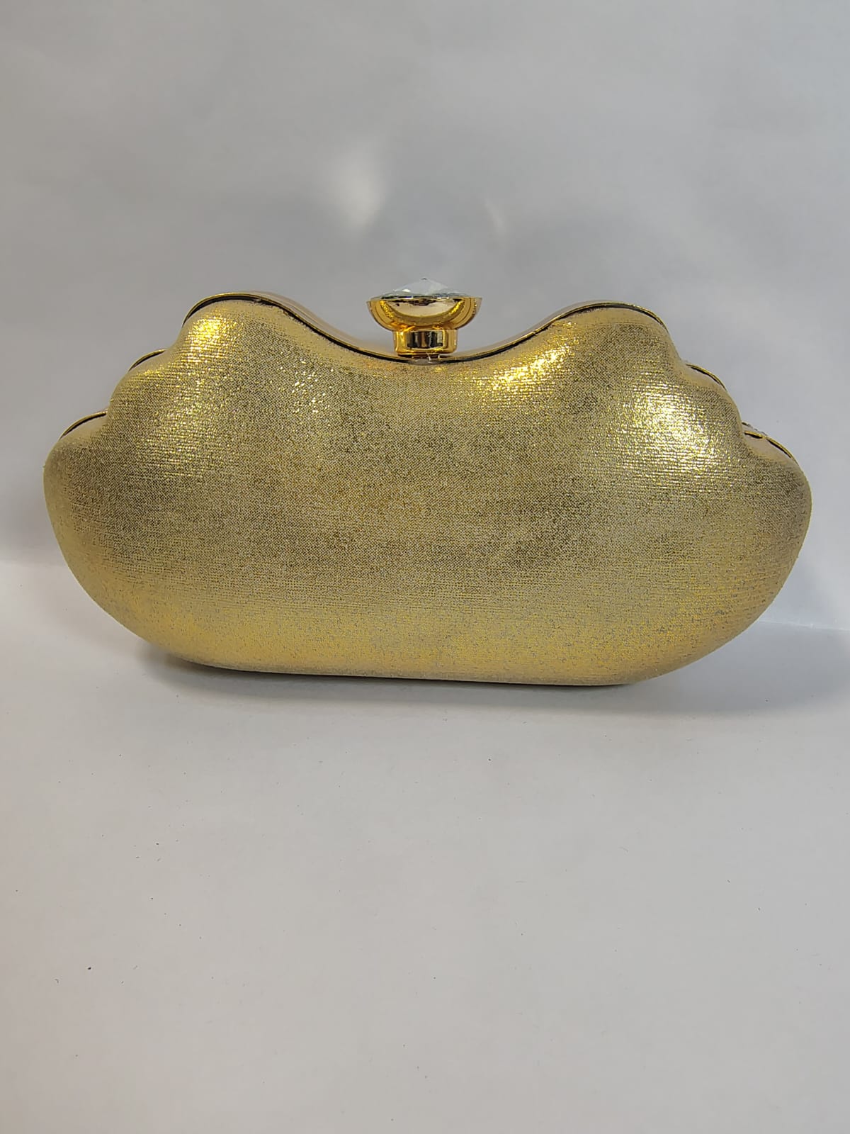 Stylish gold clutch handbag with a unique cloud design for evening occasions