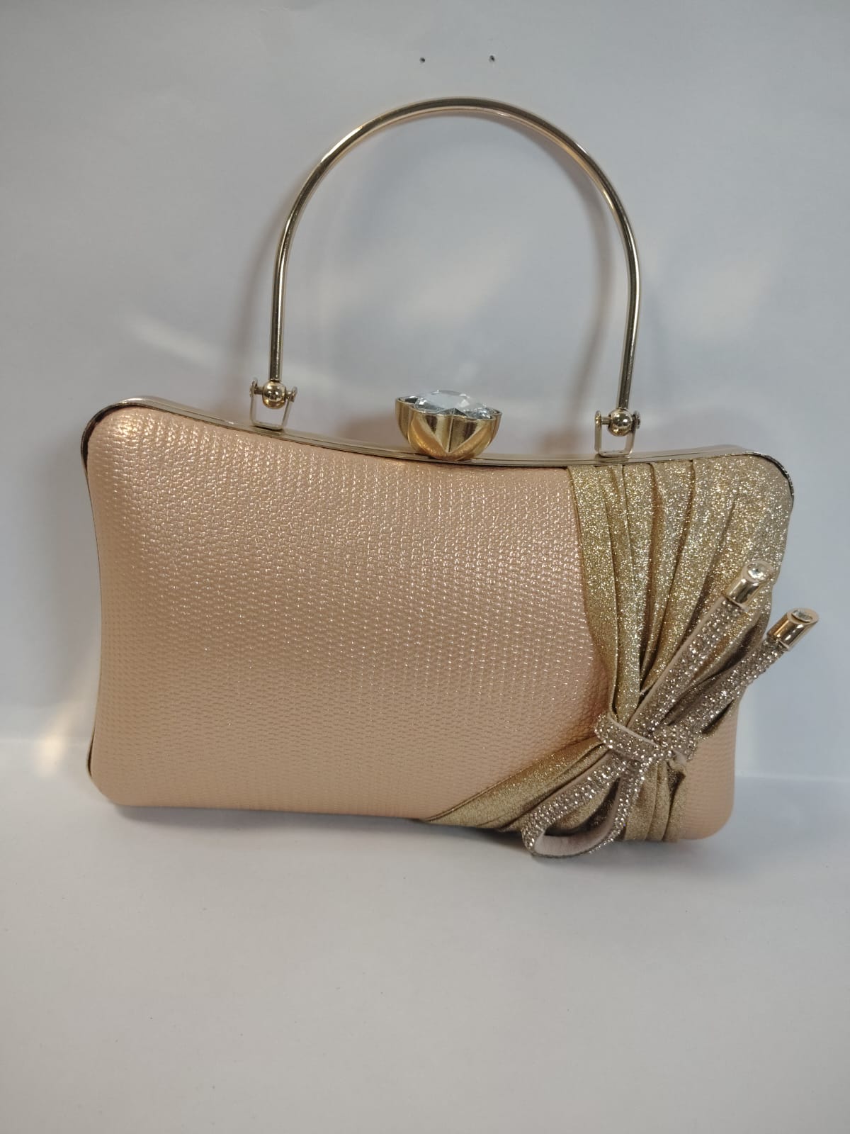 Wincham Fashion House gold clutch handbag with a bow accent and a stylish handle for elegant occasions
