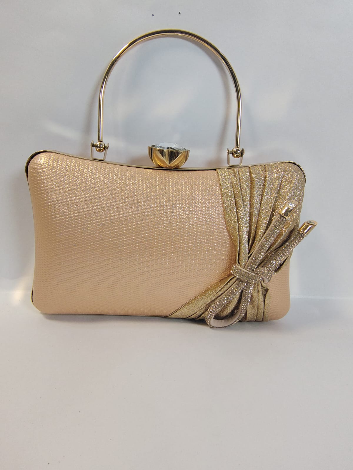 Elegant Wincham Fashion House gold clutch handbag with bow detail and metallic handle