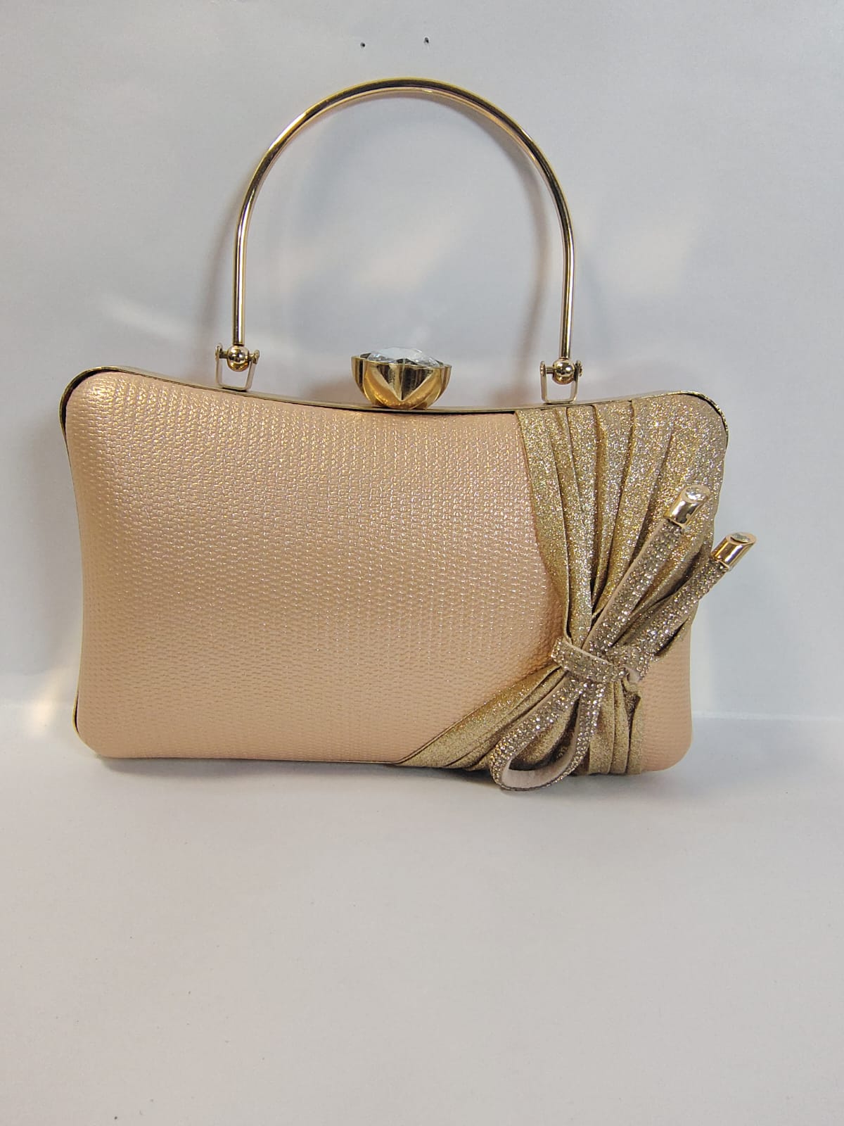 Elegant Wincham Fashion House gold clutch handbag with a stylish bow design and metal handle