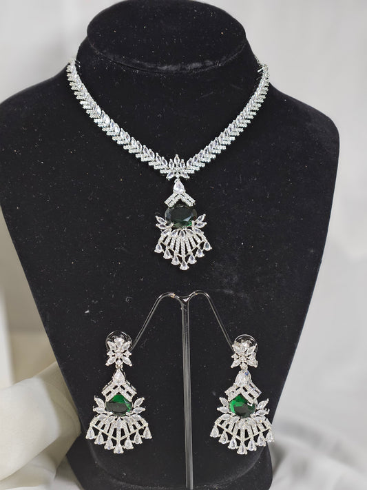 Green AD stone necklace and earring set with intricate silver design displayed on black stand