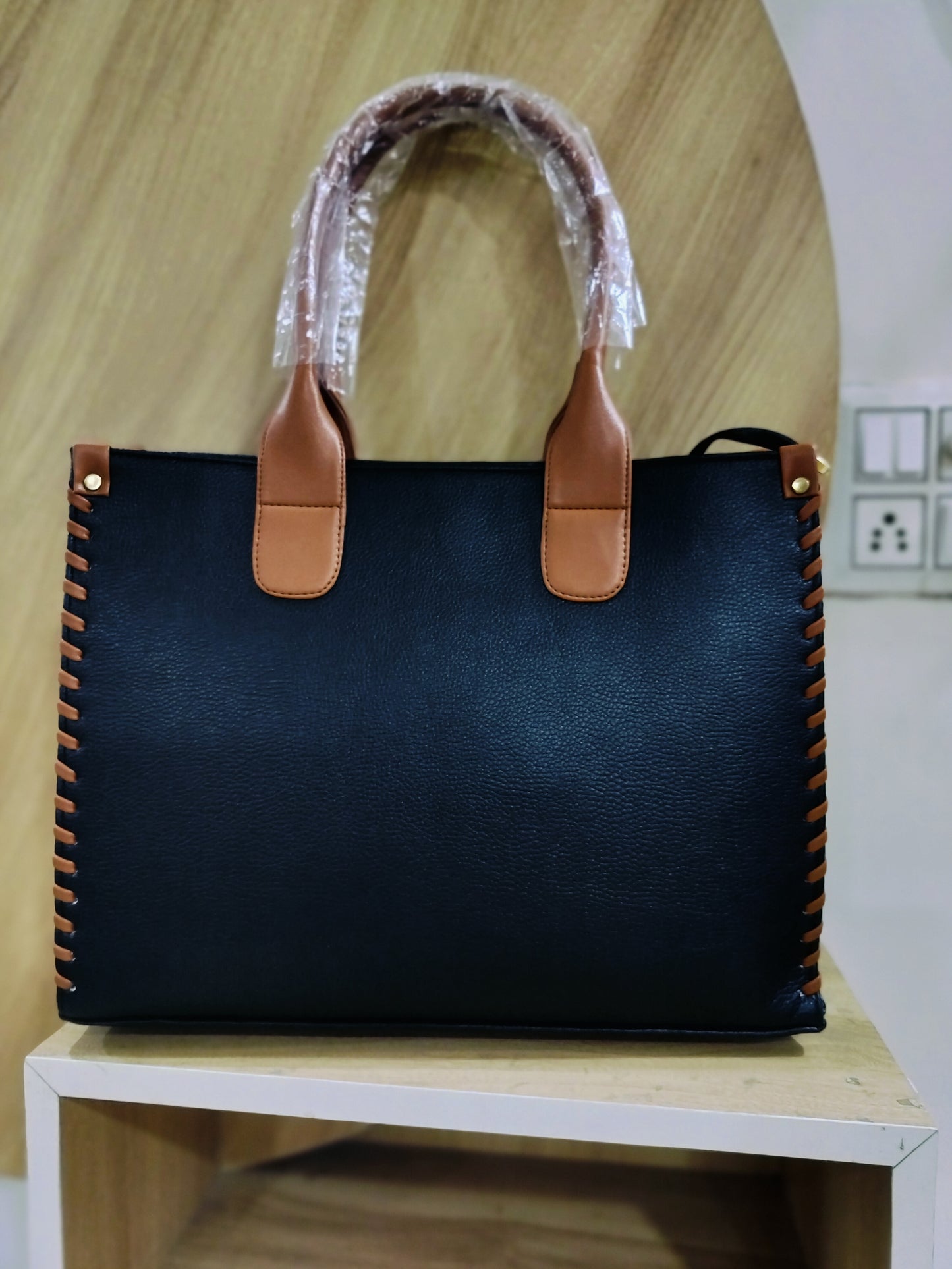 Wincham Fashion House handmade leather laptop tote in black with brown handles and stitched sides